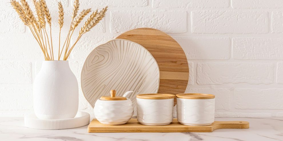 front view of beautiful kitchen utensils and white vase with ears of corn on the kitchen countertop