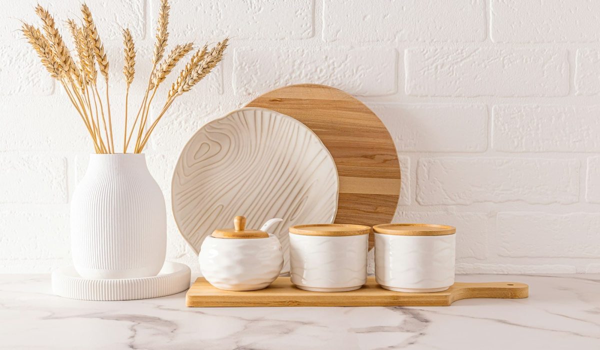 front view of beautiful kitchen utensils and white vase with ears of corn on the kitchen countertop